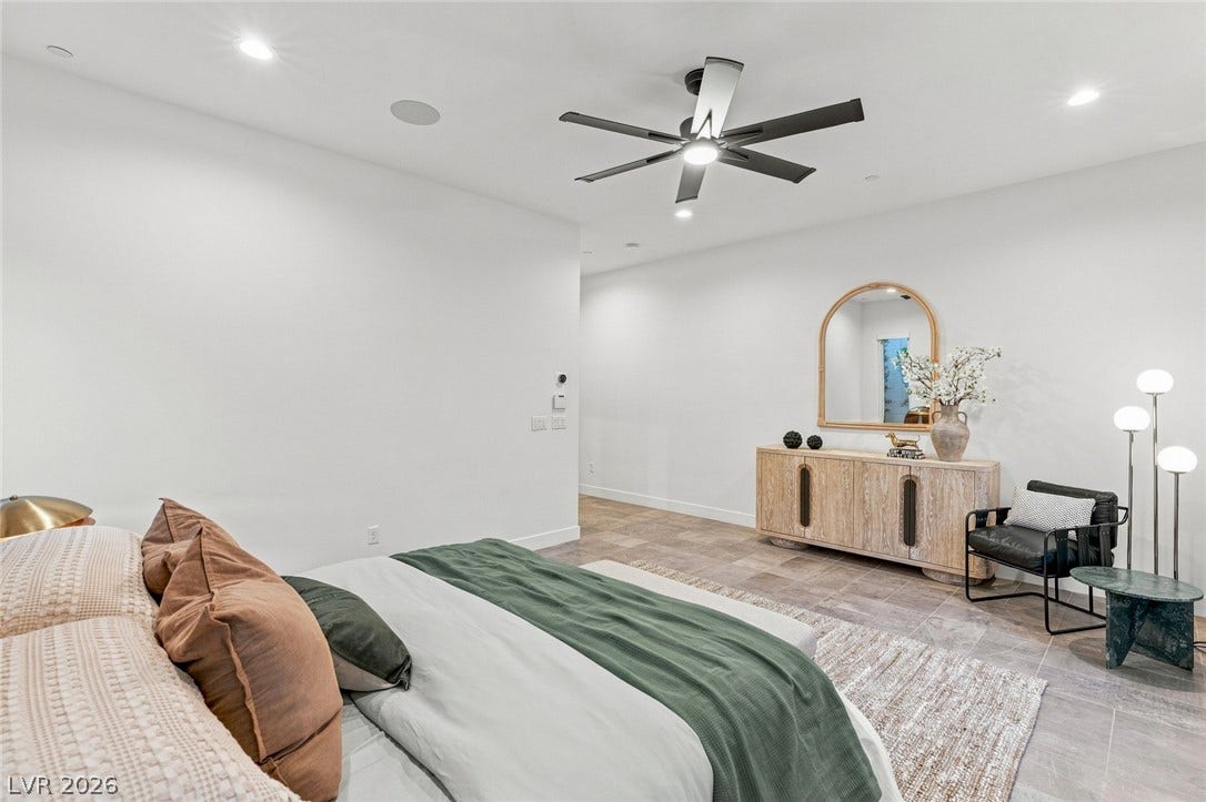 Gleaming tile floors and recessed lighting enhance the minimalist appeal of this modern bedroom.