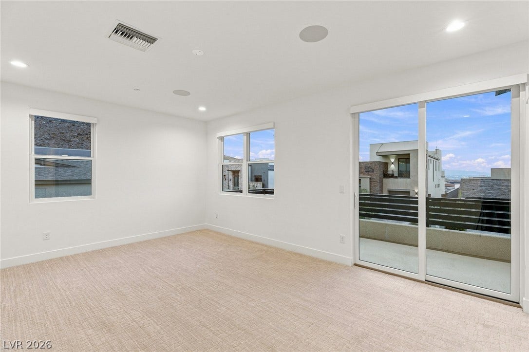 Sliding glass doors open from this carpeted room to a private balcony.