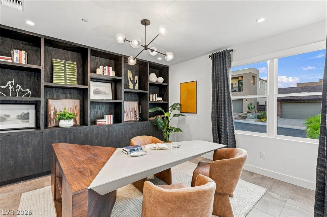 Floor-to-ceiling built-in bookcases and tile flooring define this quiet home office space.