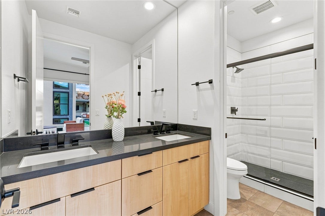 Clean lines and a spacious dual vanity define this modern bathroom layout.