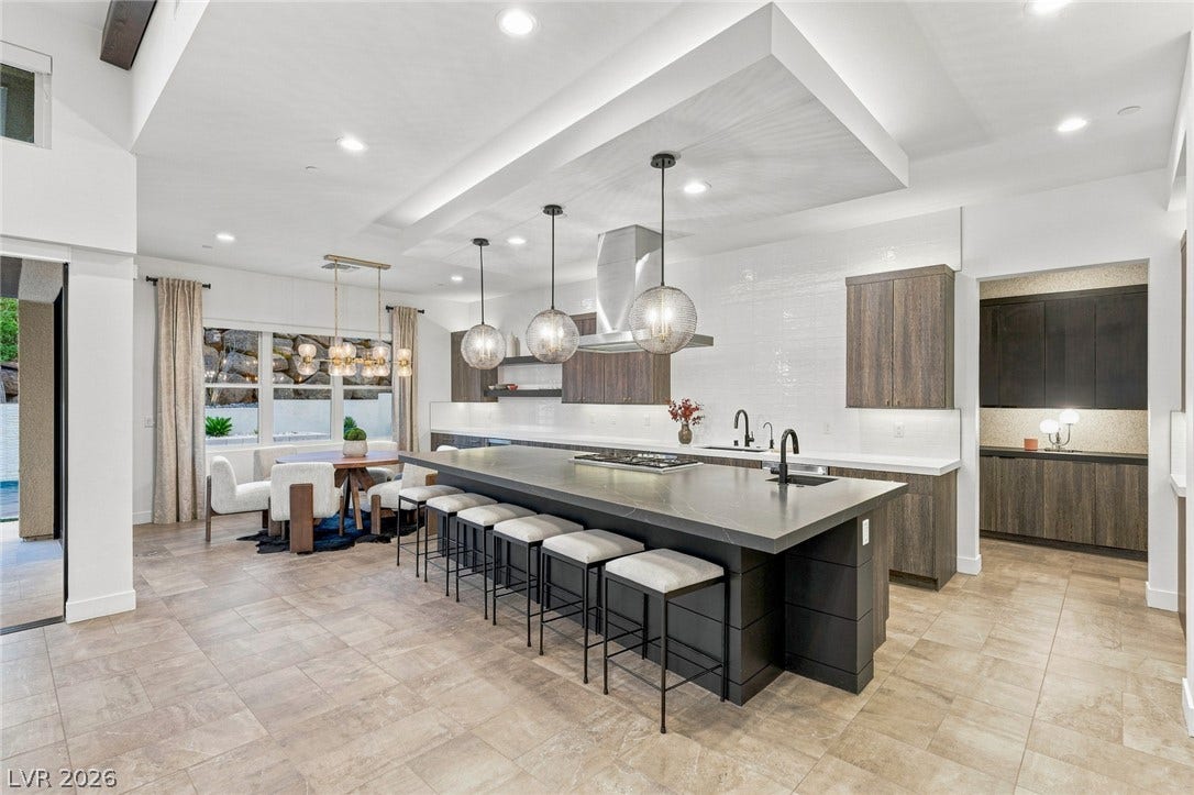 Gleaming tile floors and a massive center island define this modern chef's kitchen.