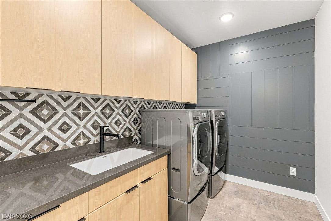 Streamlined cabinetry and patterned tiling define this highly functional workspace.