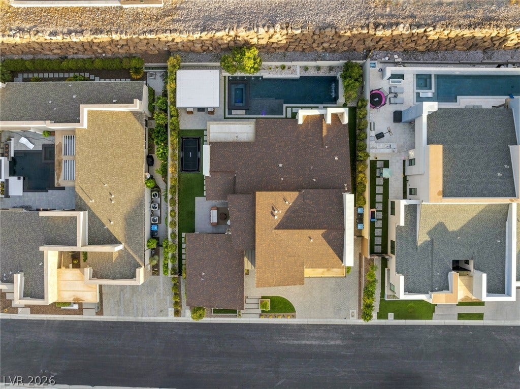 An aerial perspective reveals the structured layout of the private backyard and pool.