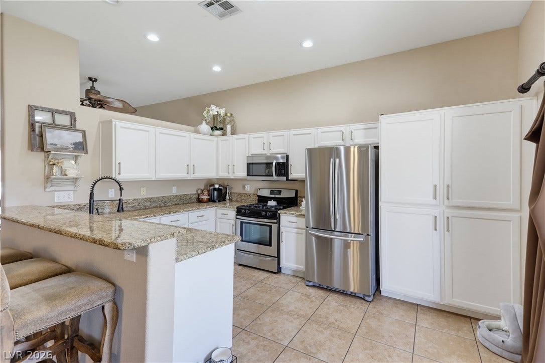 3211 Panamint Court, North Las Vegas, NV 89032 Polished stone countertops and clean cabinetry define this functional culinary space.