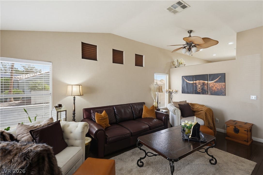 3211 Panamint Court, North Las Vegas, NV 89032 Vaulted ceilings and rich wood-toned flooring anchor this welcoming living area.