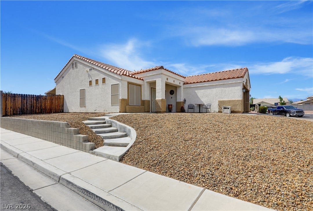 3211 Panamint Court, North Las Vegas, NV 89032 A curved concrete staircase leads to the main entrance of this stucco home.