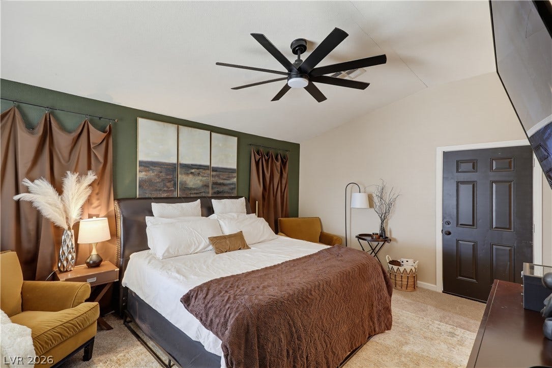 3211 Panamint Court, North Las Vegas, NV 89032 An inviting sleeping space highlighted by a vaulted ceiling and soft carpeted flooring.