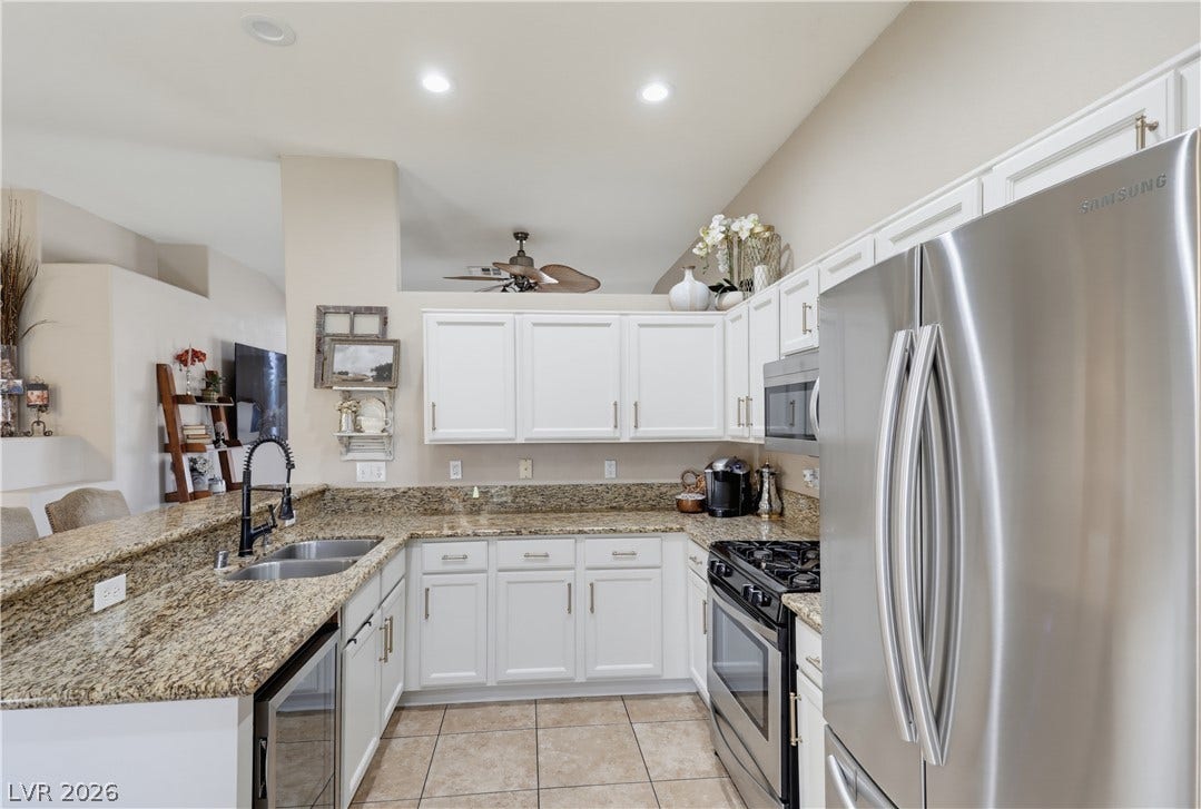 3211 Panamint Court, North Las Vegas, NV 89032 Gleaming stone countertops and classic cabinetry anchor this functional cooking space.