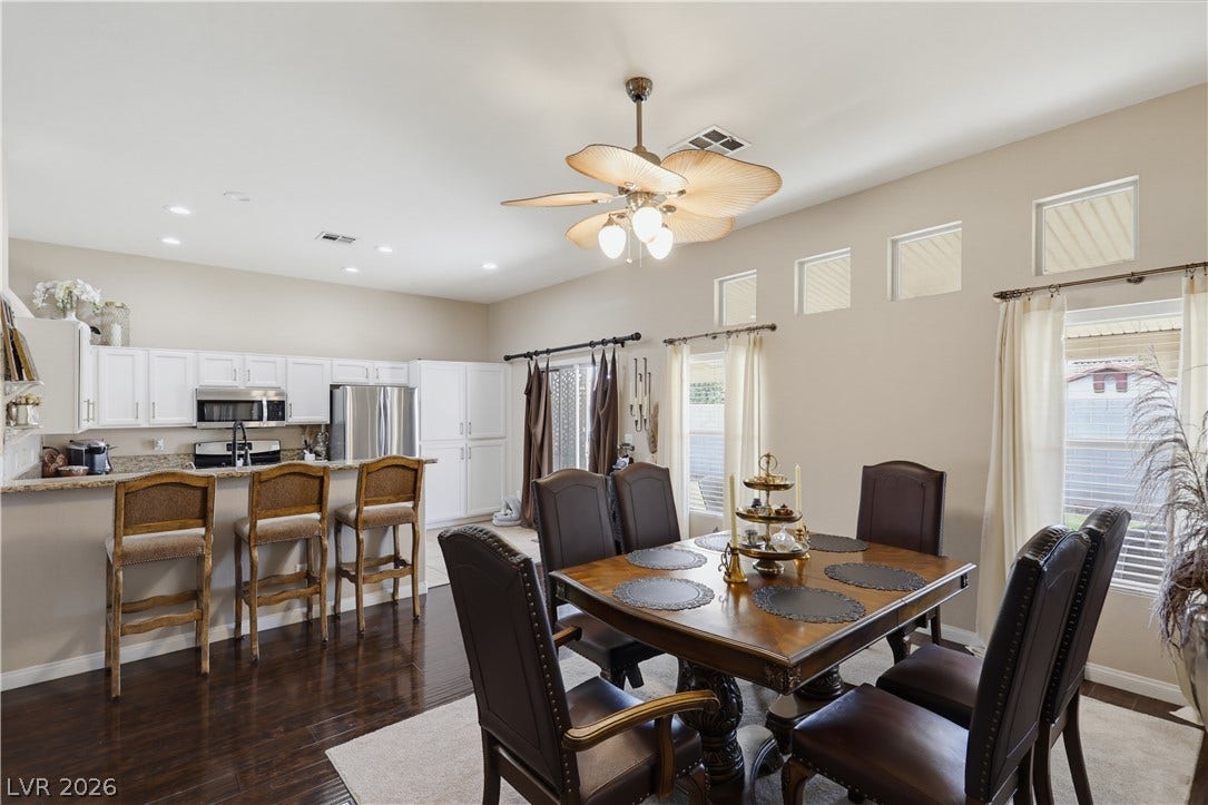 3211 Panamint Court, North Las Vegas, NV 89032 Rich floors anchor this open concept dining space flowing into the modern kitchen.
