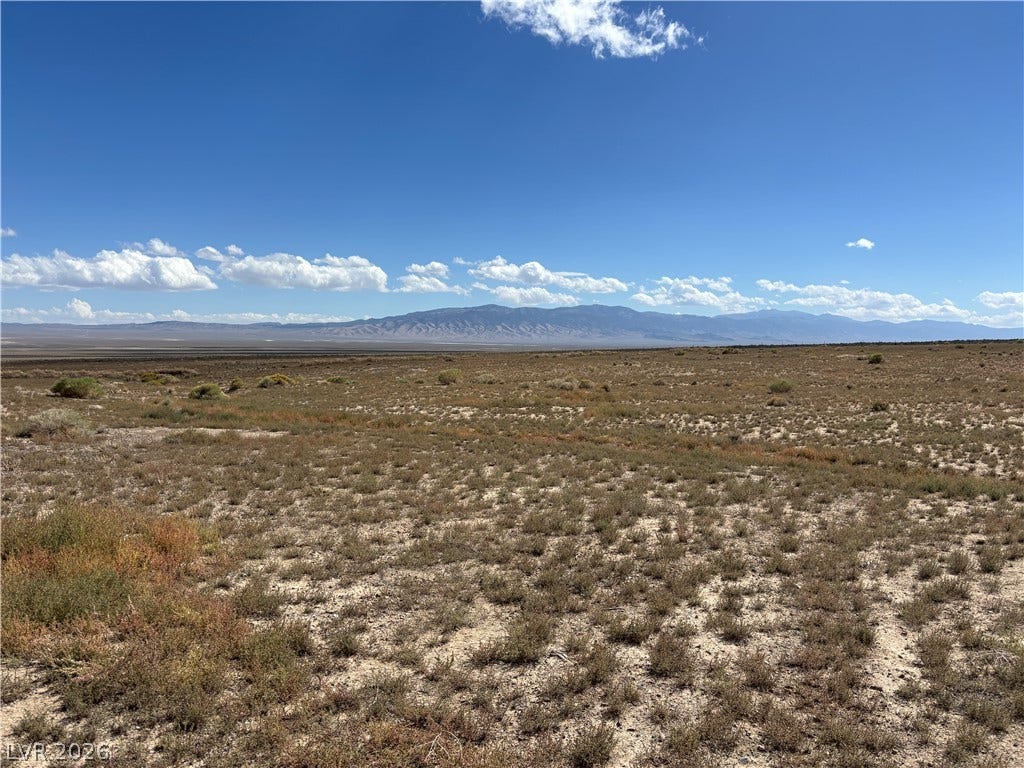 WP Co. WP Co. Road 31 (N. Spring Valley Rd), Ely, NV 89301 Distant mountains frame the wide horizon of this open desert landscape under blue skies.