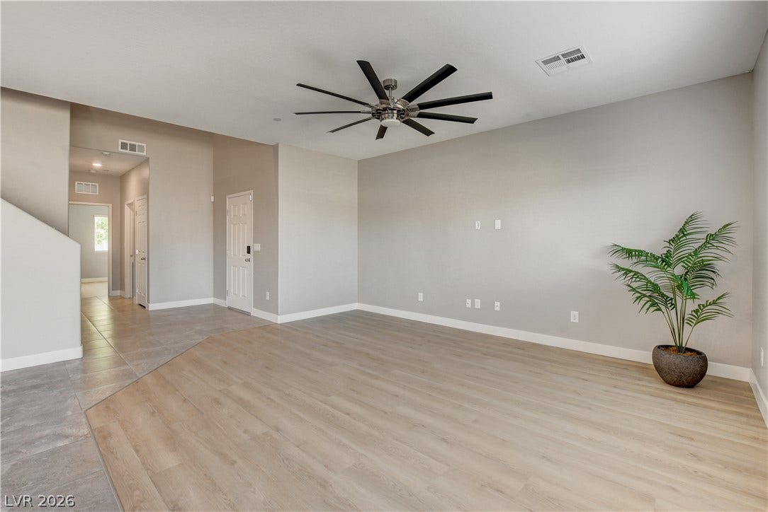 Clean lines and smooth flooring define this versatile, open living space.