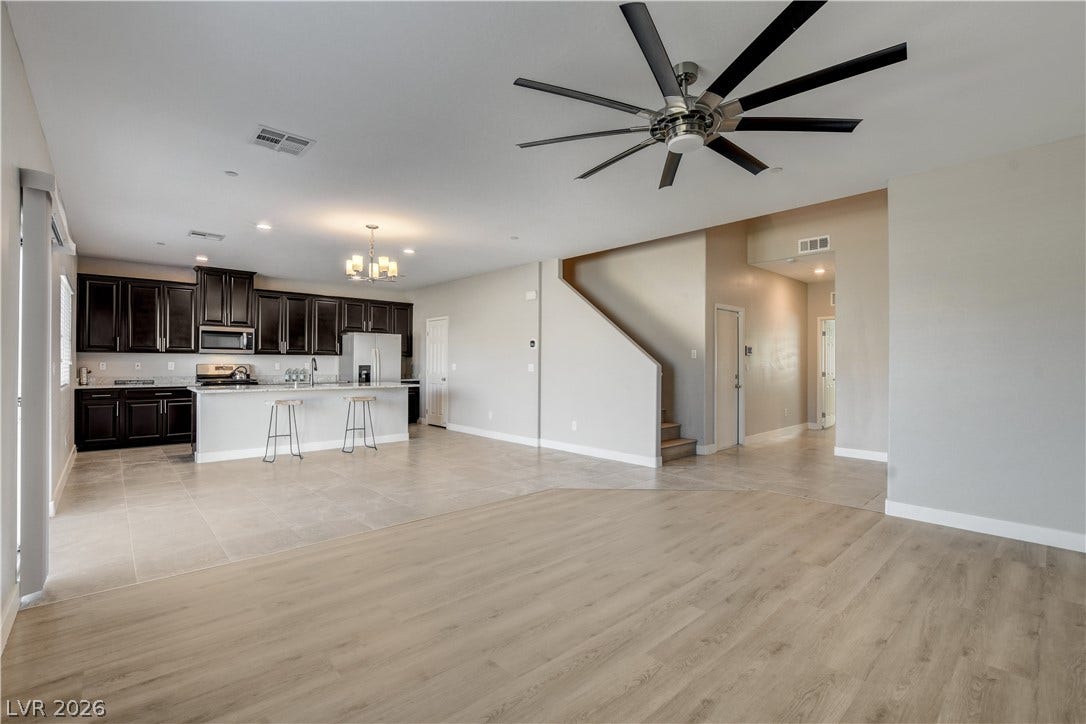 Clean lines and smooth flooring define this versatile open living space.