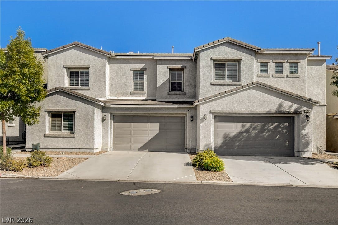 Clean lines and a stucco exterior define this multi-level residential design.