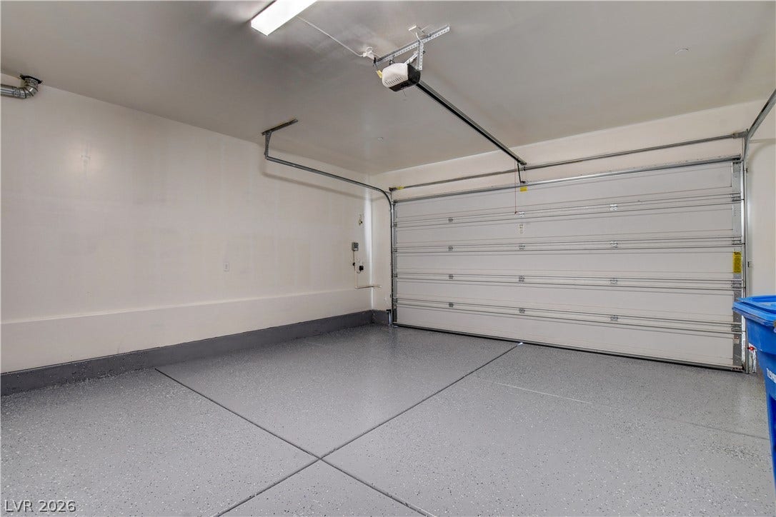 Finished walls and durable floor coating complete this spacious vehicle storage area.