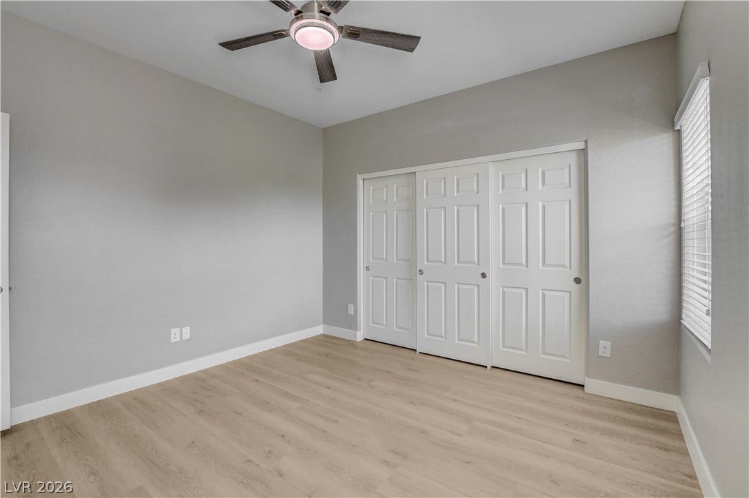 Smooth wood-look flooring and integrated closets highlight this versatile interior space.
