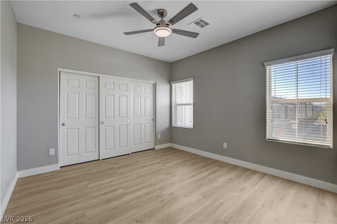 Clean lines and smooth flooring define this versatile secondary bedroom space.