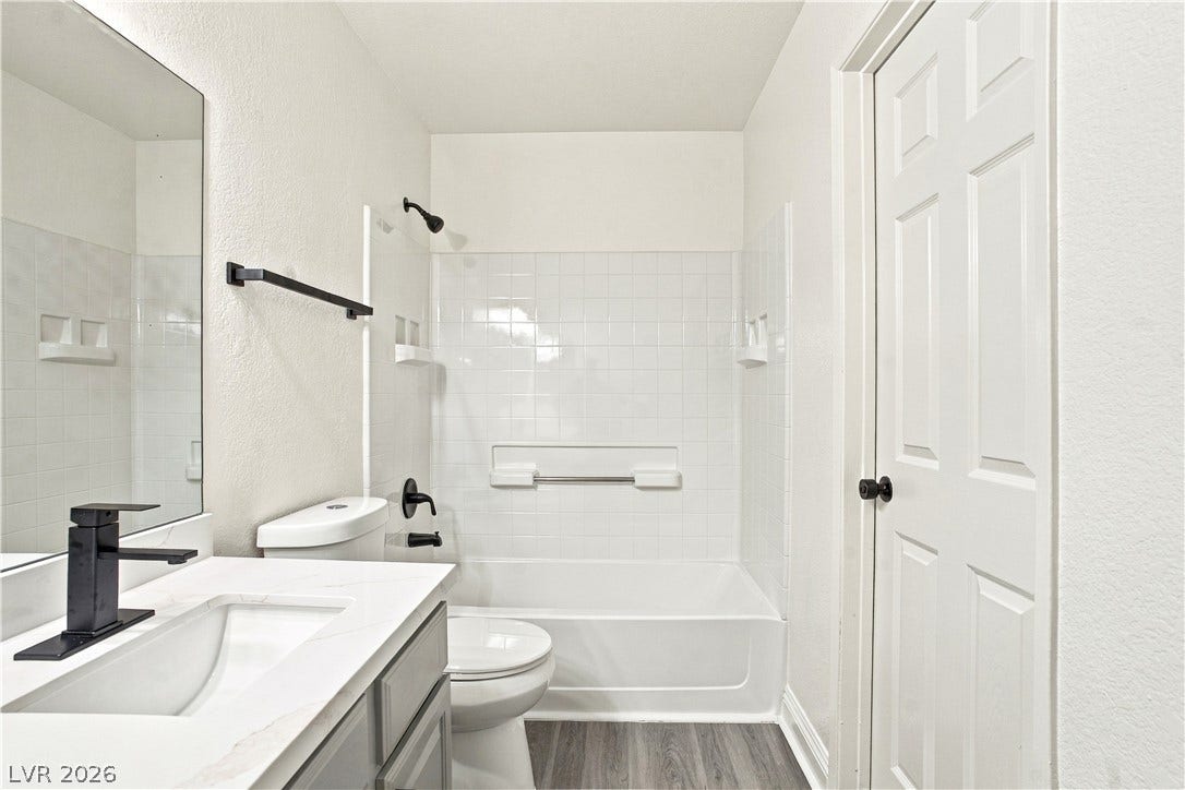 6800 Lake Mead, #2117, Las Vegas, NV 89156 Clean lines and stone-look countertops define this modern bathroom with a classic tub-shower combination.
