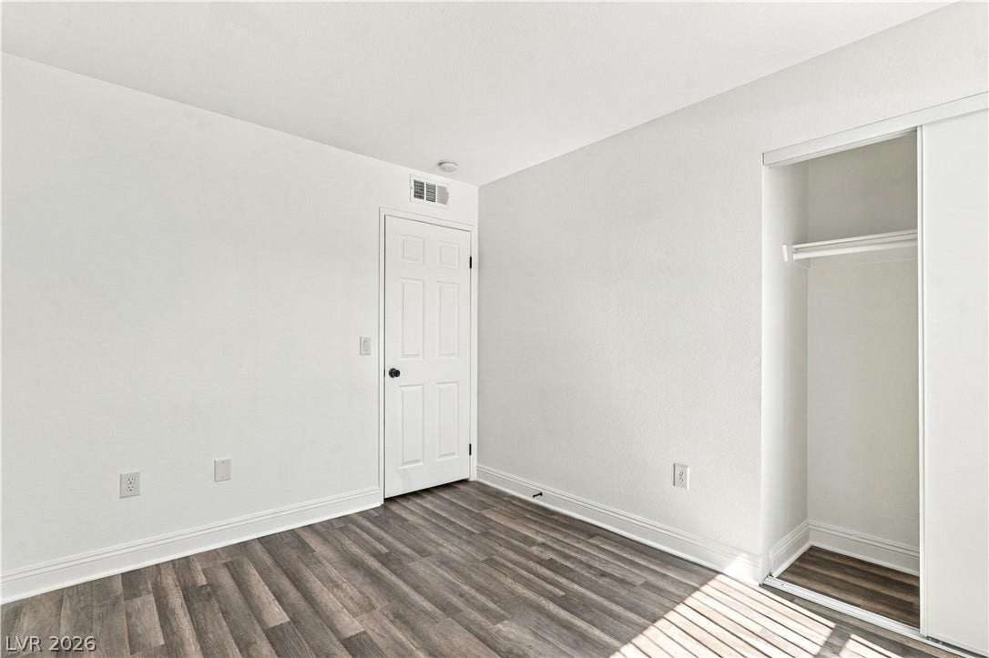 6800 Lake Mead, #2117, Las Vegas, NV 89156 Rich wood-inspired flooring pairs beautifully with clean plaster walls in this versatile bedroom.