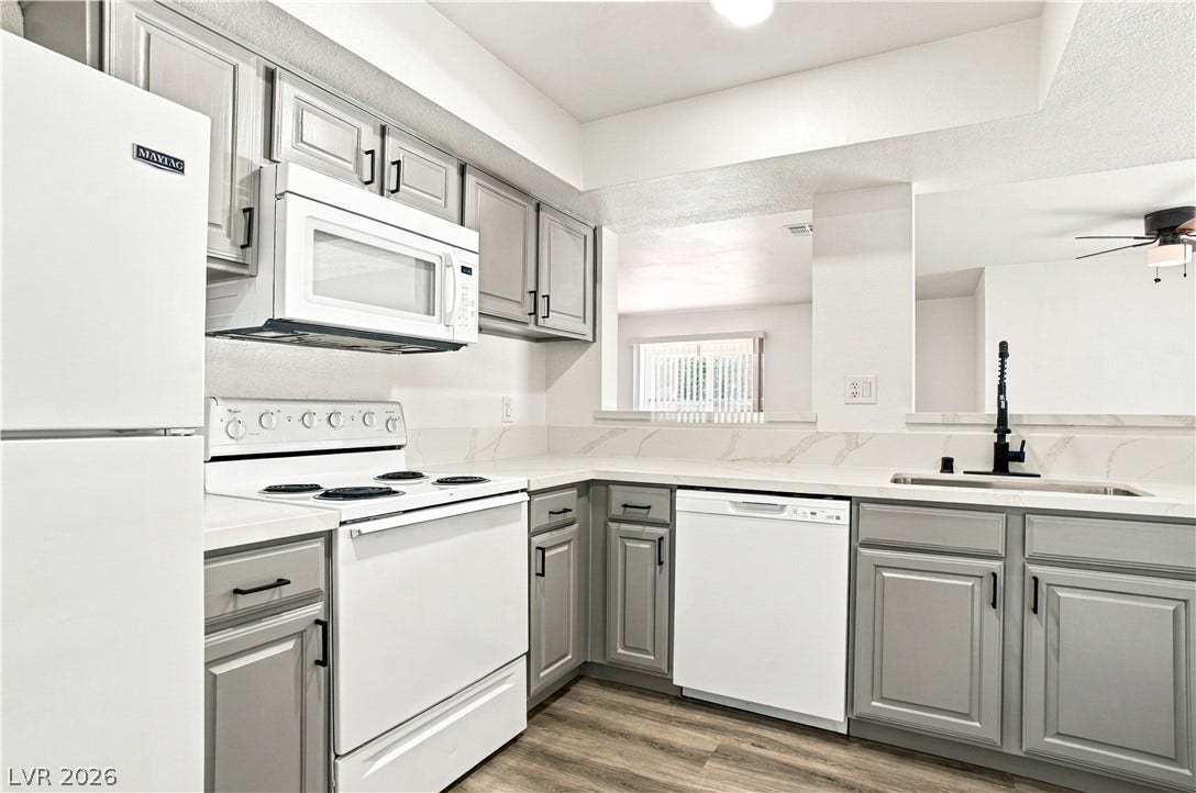 6800 Lake Mead, #2117, Las Vegas, NV 89156 Streamlined cabinetry and sleek stone countertops define this efficiently designed modern culinary space.