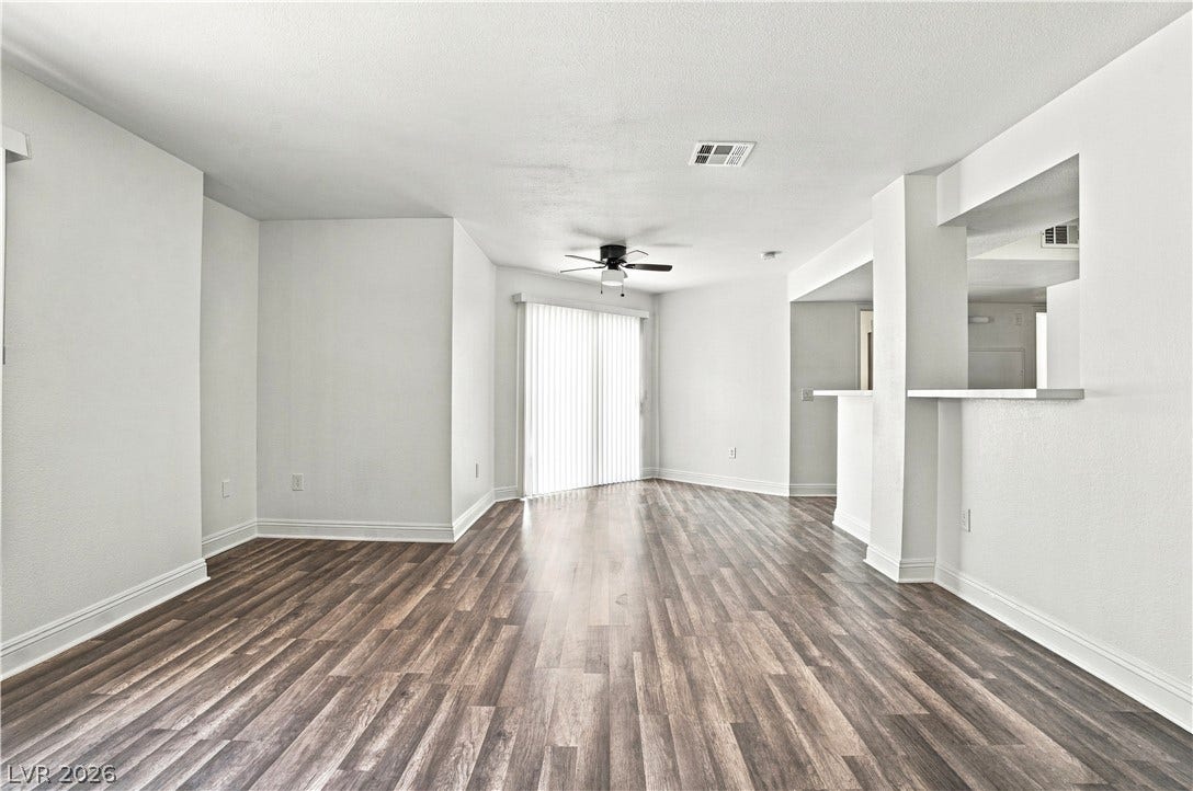 6800 Lake Mead, #2117, Las Vegas, NV 89156 Rich wood-look flooring and clean lines define this versatile, open living area.