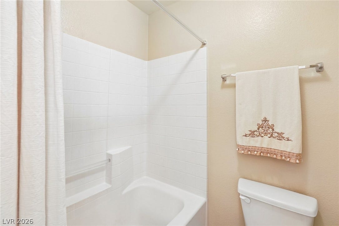 4024 Solar System Street, North Las Vegas, NV 89032 White subway tile surrounds the classic bathtub in this clean bathroom.