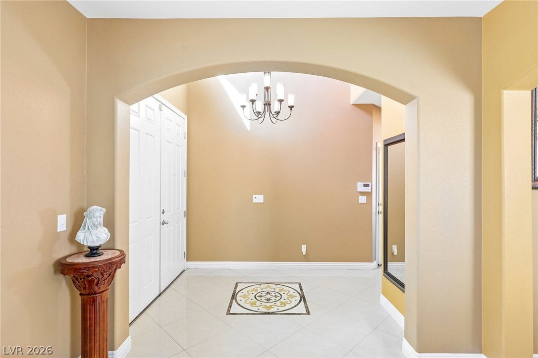 4024 Solar System Street, North Las Vegas, NV 89032 An elegant arched opening leads into a soaring foyer featuring custom tile inlay flooring.