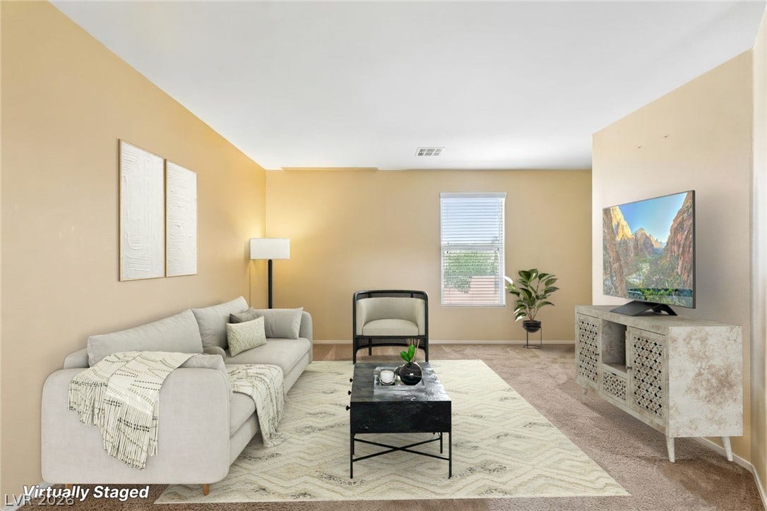 4024 Solar System Street, North Las Vegas, NV 89032 Smooth plaster walls and soft carpeting define this welcoming living space.