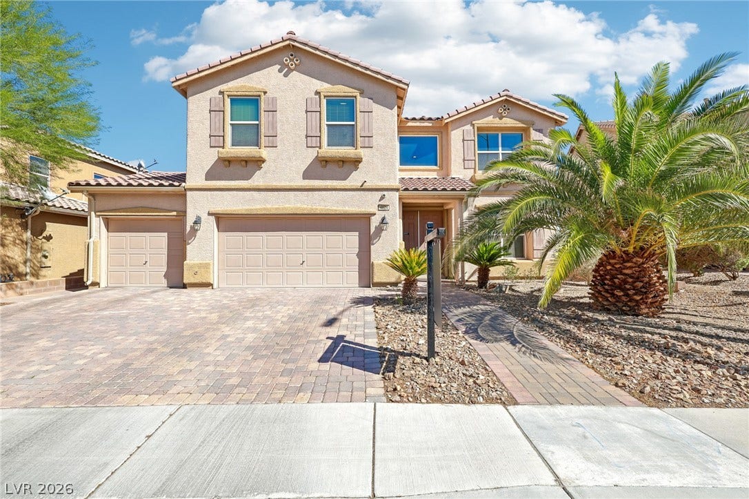 4024 Solar System Street, North Las Vegas, NV 89032 Elegant two-story exterior features a paved driveway, classic stucco walls, and desert landscaping.