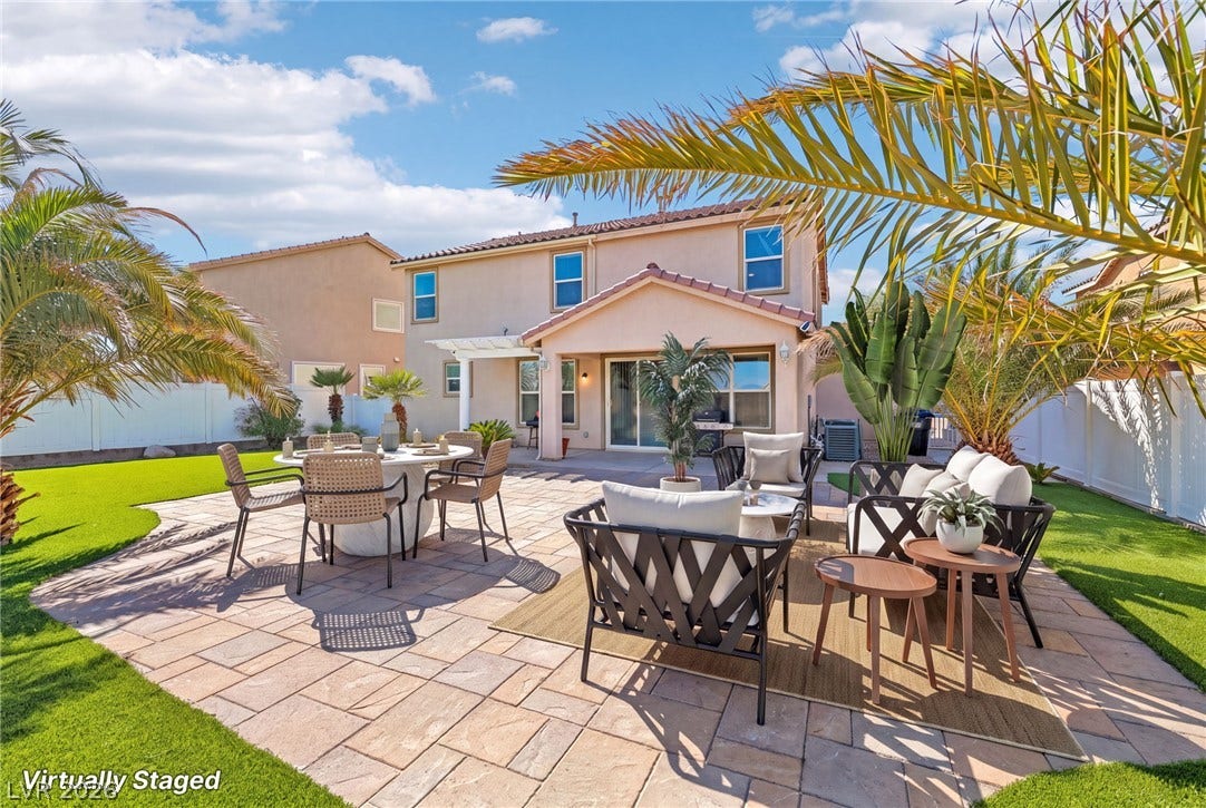 4024 Solar System Street, North Las Vegas, NV 89032 A spacious stone paver patio sits framed by palm trees behind the two-story residence.