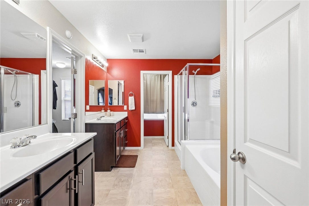 4024 Solar System Street, North Las Vegas, NV 89032 A spacious layout incorporates a dual-vanity setup alongside a separate soaking tub and walk-in shower.