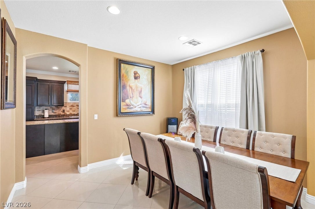 4024 Solar System Street, North Las Vegas, NV 89032 An arched doorway connects the elegant dining area directly to the kitchen.