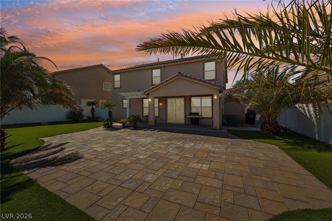 4024 Solar System Street, North Las Vegas, NV 89032 An expansive paver patio sits under a covered porch overlooking a manicured lawn.