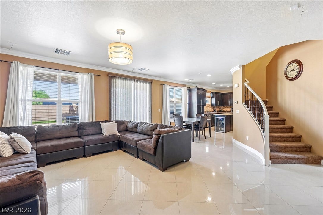 4024 Solar System Street, North Las Vegas, NV 89032 Polished tile flooring and an open layout seamlessly connect the living areas.