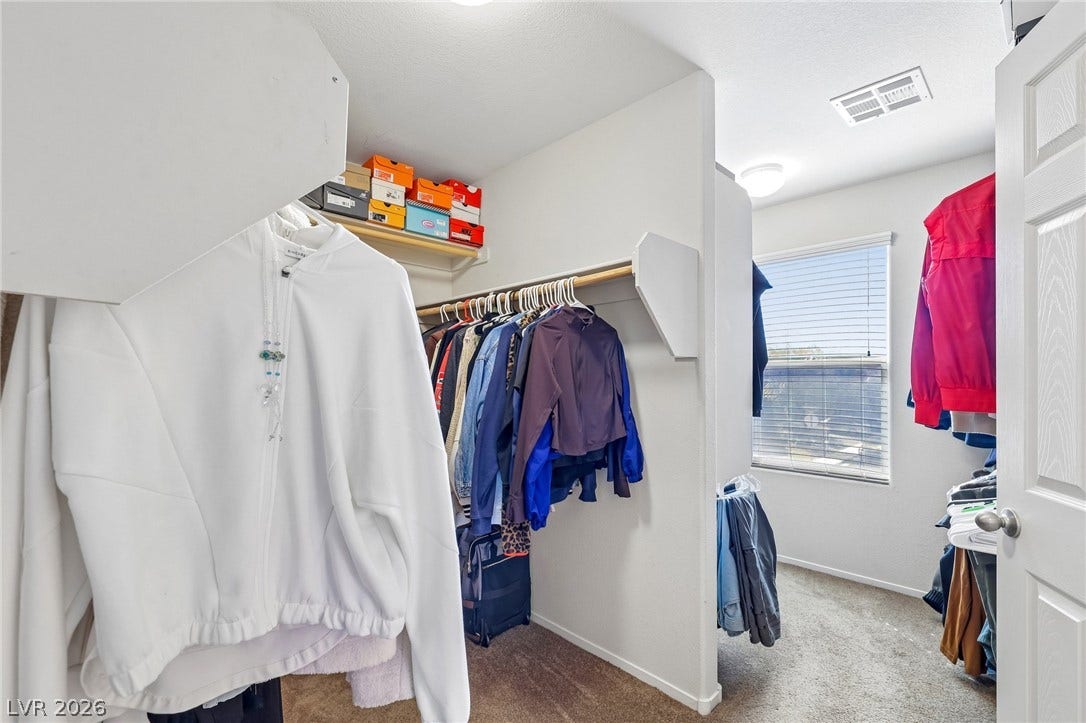 4024 Solar System Street, North Las Vegas, NV 89032 Ample hanging rods and built-in shelving maximize storage space in this carpeted walk-in closet.
