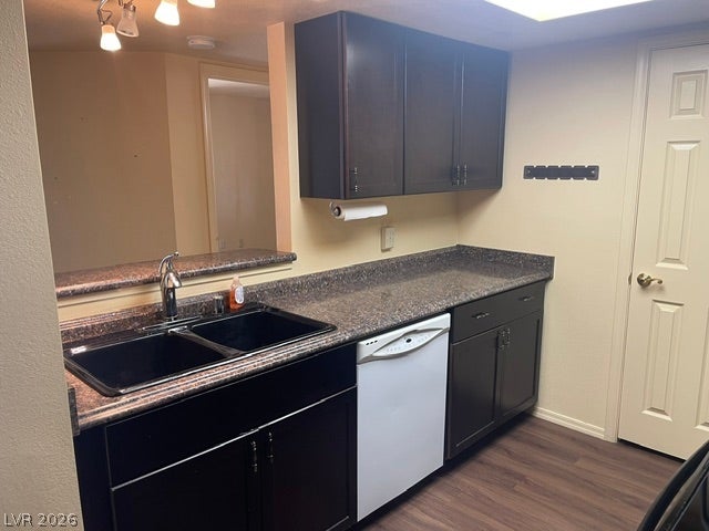 3550 Bay Sands Drive, #1017, Laughlin, NV 89029 Dark cabinetry complements the durable countertops and wood-look flooring in this functional kitchen space.