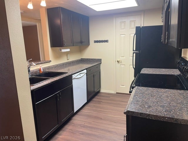 3550 Bay Sands Drive, #1017, Laughlin, NV 89029 Dark cabinetry and wood-look flooring establish a classic tone in this functional galley kitchen.