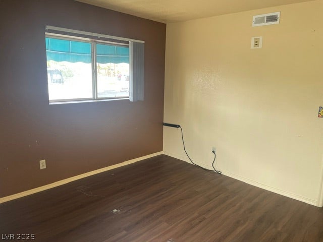 3550 Bay Sands Drive, #1017, Laughlin, NV 89029 Rich wood-look flooring anchors this Primary bedroom illuminated by a wide window.