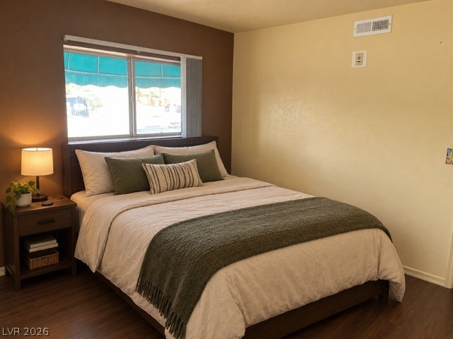 3550 Bay Sands Drive, #1017, Laughlin, NV 89029 Rich wood-look flooring and a wide window create a restful, welcoming atmosphere in this bedroom.