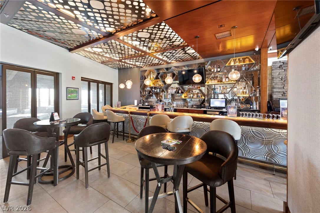 1357 Enchanted River Drive, Henderson, NV 89012 A customized bar area showcases distinctive ceiling details and tiled flooring.
