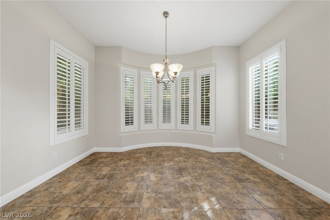1357 Enchanted River Drive, Henderson, NV 89012 Tiled flooring and elegant plantation shutters define this versatile dining area.