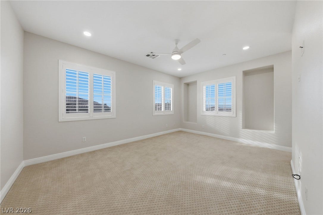 1357 Enchanted River Drive, Henderson, NV 89012 Plentiful natural light streams through plantation shutters into this versatile carpeted space.