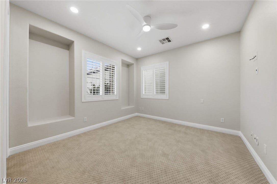 1357 Enchanted River Drive, Henderson, NV 89012 Plush carpeting and plantation shutters define this versatile secondary bedroom space.