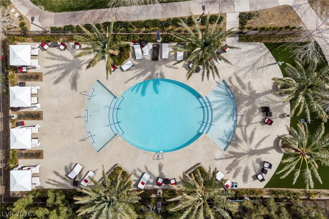 1357 Enchanted River Drive, Henderson, NV 89012 An aerial perspective showcases a circular resort-style swimming pool lined with towering palm trees.