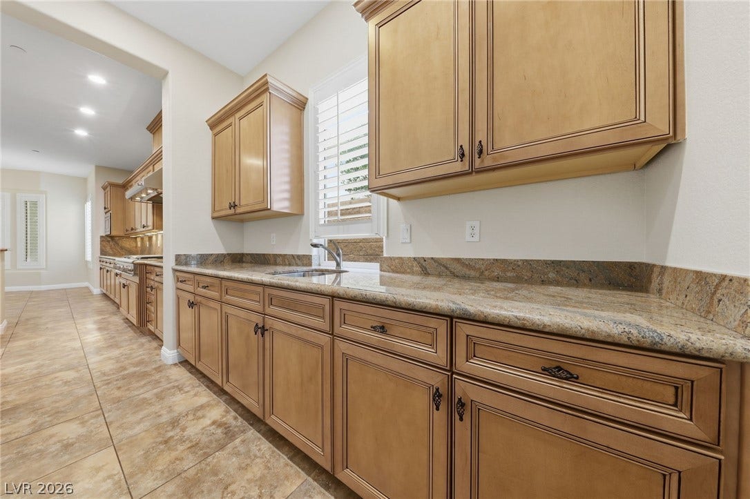 1357 Enchanted River Drive, Henderson, NV 89012 Ample counter space and classic cabinetry define this functional butler's pantry area.