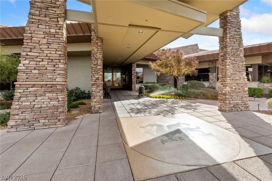 1357 Enchanted River Drive, Henderson, NV 89012 Robust stone pillars support the grand covered entry leading to the main building.