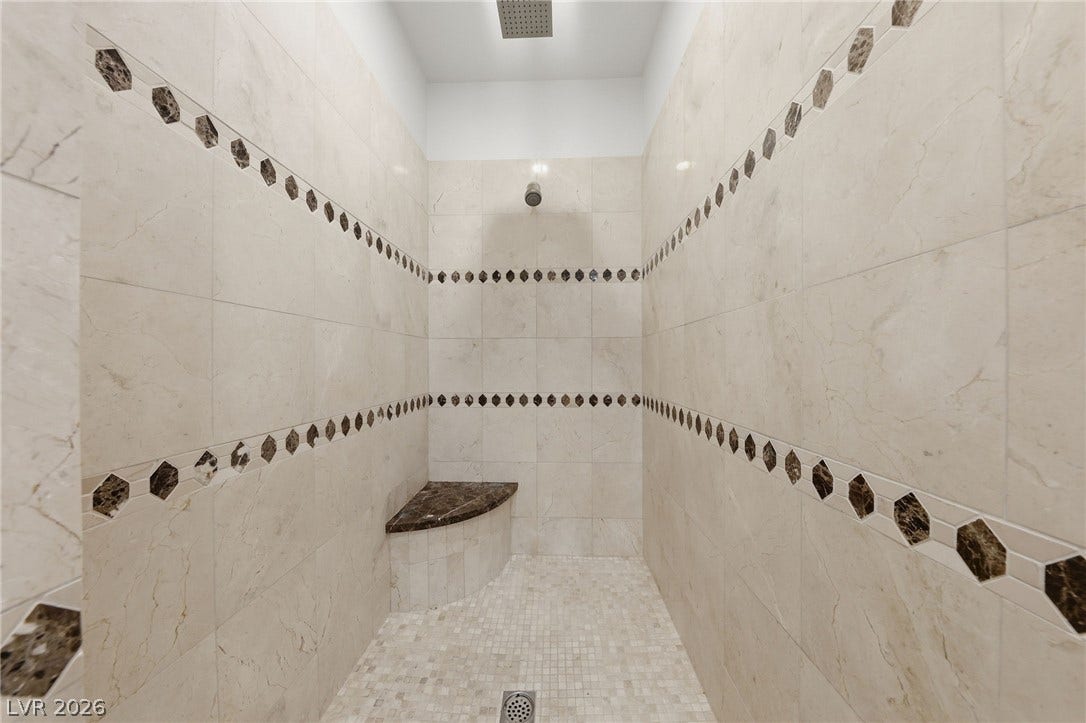 1357 Enchanted River Drive, Henderson, NV 89012 Ornate tile surrounds this walk-in shower featuring a built-in corner bench.