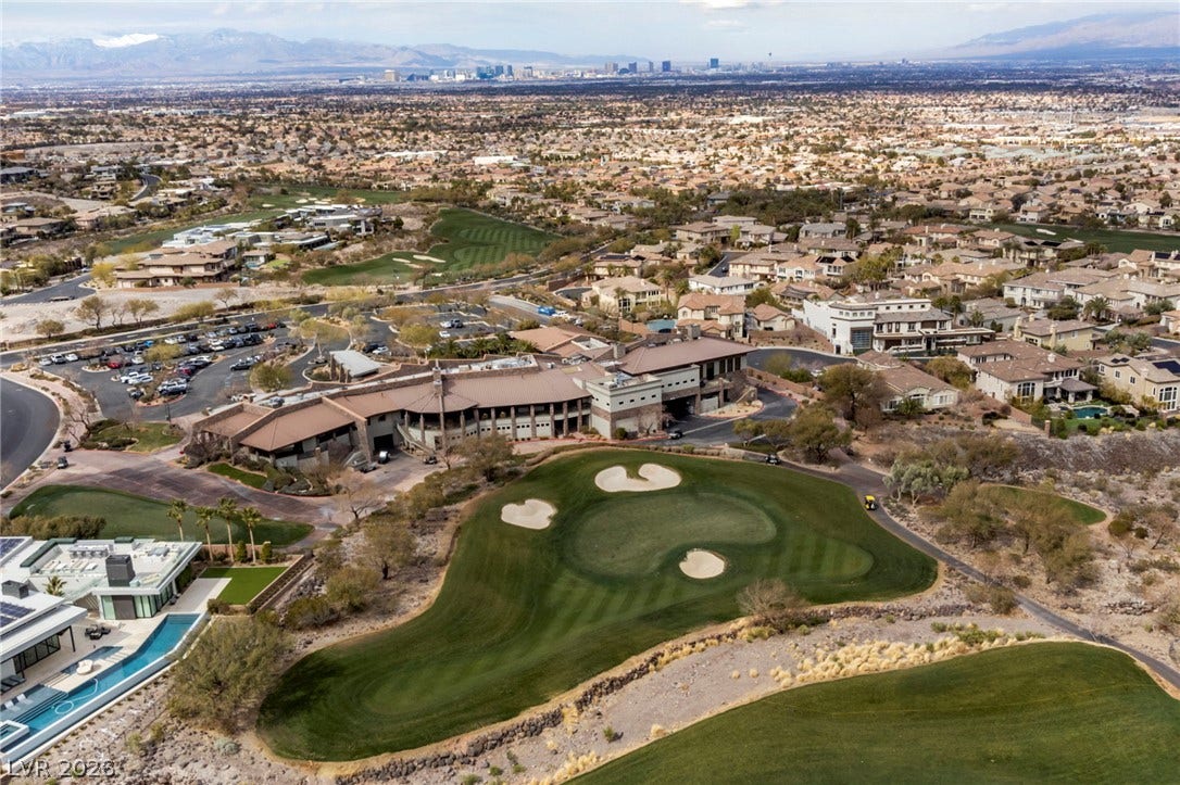 1357 Enchanted River Drive, Henderson, NV 89012 An aerial perspective reveals manicured golf course greens bordering an exclusive desert neighborhood community.