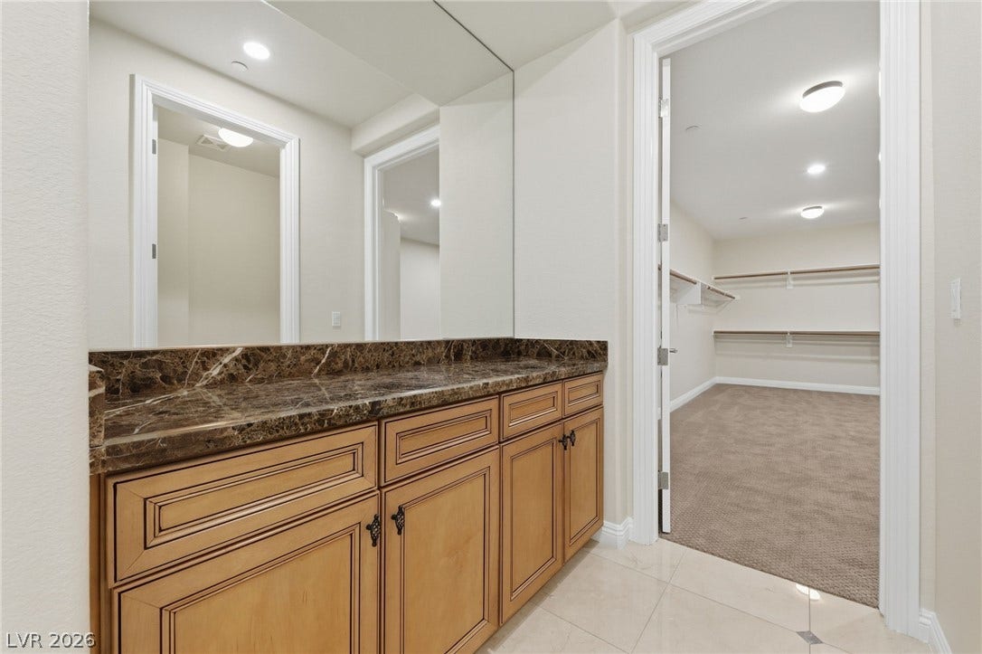 1357 Enchanted River Drive, Henderson, NV 89012 Rich marble countertops and polished tile floors lead directly into a spacious walk-in closet.