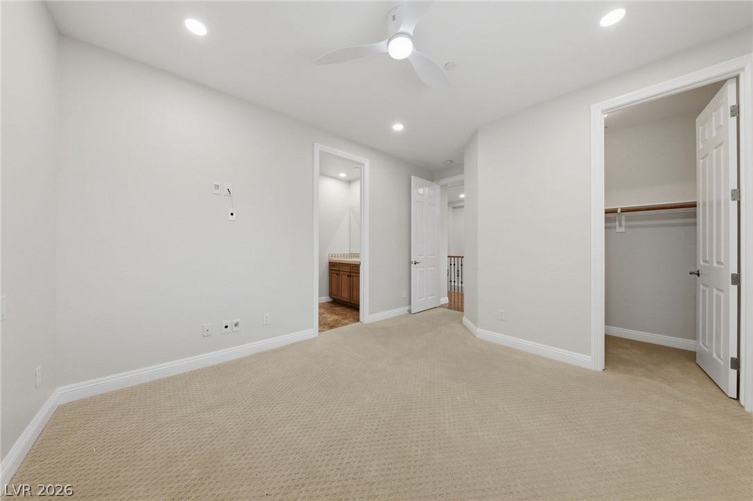 1357 Enchanted River Drive, Henderson, NV 89012 Plush carpeting anchors this versatile room featuring a walk-in closet and an adjacent bathroom.