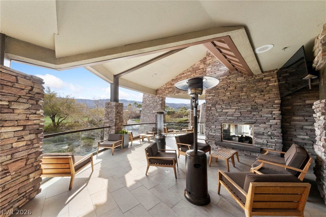 1357 Enchanted River Drive, Henderson, NV 89012 An inviting covered patio offers timeless stone accents alongside scenic nature views.